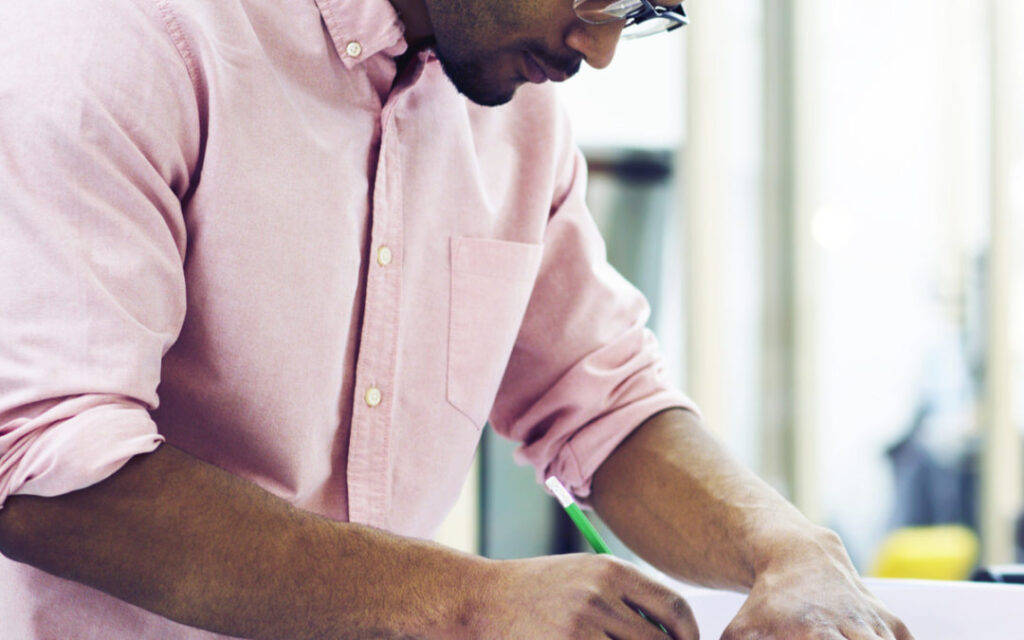 Man with pencil designing engineering project